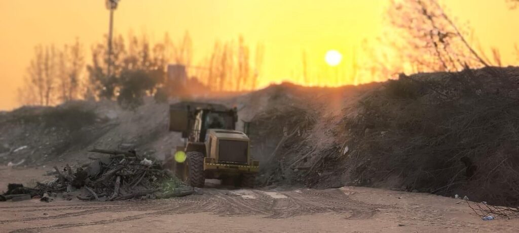 Wheel loader clearing at sunset