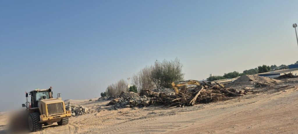 Wheel loader clearing debris