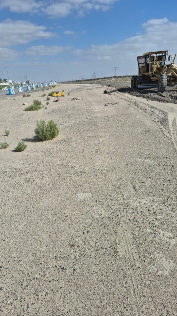 Motor grader levelling the road